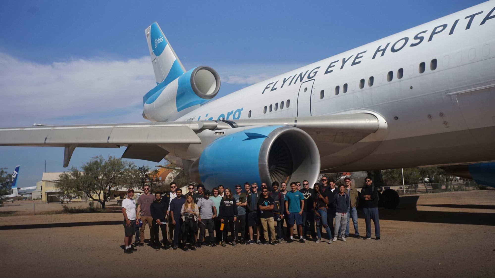 Museum visitors gathered around an airplane